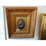 A framed portrait in ornamental frame