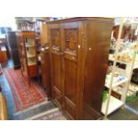 A carved Oak gents fitted wardrobe