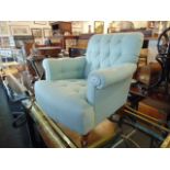 A light blue button back armchair