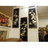 A set of four oriental lacquered panels