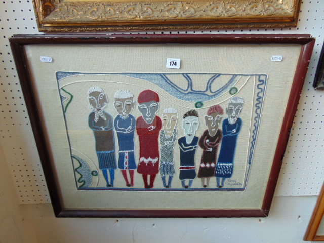 A framed embroidered collage,