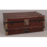 A wood and brass bound twin handled trunk.