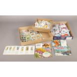 A selection of collectables. To include a box of Brooke Bond card sets, 25 full sets, five full