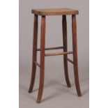 An early twentieth century ash/elm stool on oak legs and supports.