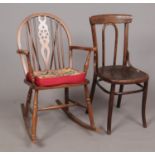 A wheel and spindleback rocking chair, accompanied by a mahogany bentwood chair with shell decorated