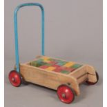 Tri- Ang Baby walker with wooden blocks.