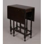 A dark hardwood drop leaf and gate leg table. H: 73cm, W: 86cm fully open.