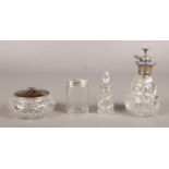 Four glass vanity items. To include a silver lidded bowl, a Silver collared scent bottle and an