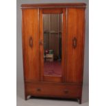 A 1930s-40s carved mahogany 3 piece bedroom suite. Comprising of mirror front wardrobe, dressing