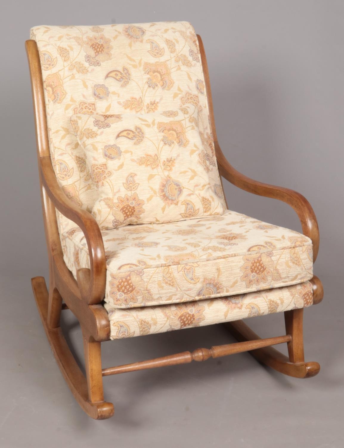 An Ercol style curved rocking chair, with scrolled arms in a light finish. Seat has light brown