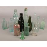 A quantity of glass advertising bottles. Including Sharps, Burdall & Burdall, etc.