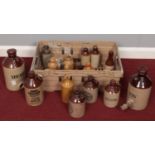 A box of advertising stoneware storage jars/flagons. Including Heineken, Parsons, etc.