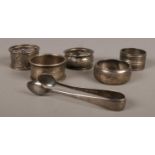 A small quantity of silver and silver plate items, composed of napkin rings and sugar tongs. Two