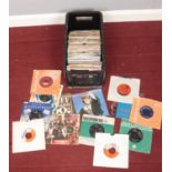 A box of single records. Including Beatles, Rolling Stones, David Bowie, etc.