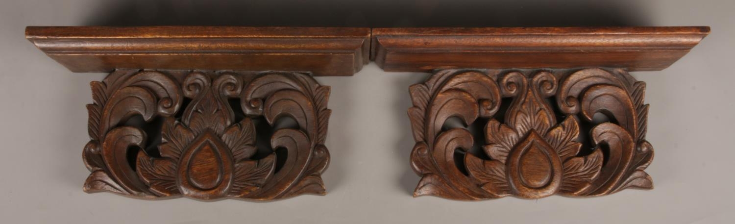 A pair of large oak Sconces/Wall Shelves with carved foliate. Width: 43cm.