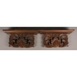 A pair of large oak Sconces/Wall Shelves with carved foliate. Width: 43cm.