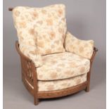 An Ercol 'New Renaissance' oversize low armchair in Golden Dawn finish, with light brown and cream