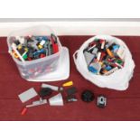 A container and bag containing an assortment of Lego.