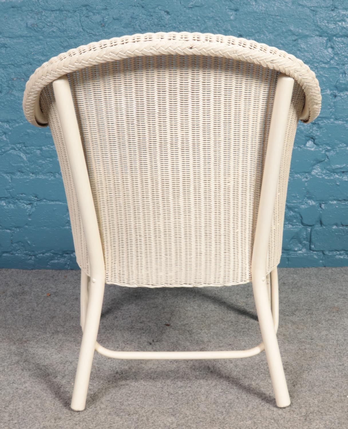 A Lloyd Loom Lusty white chair with floral seat cushion. H: 74cm, W:51.5cm, D: 43cm. - Image 4 of 4