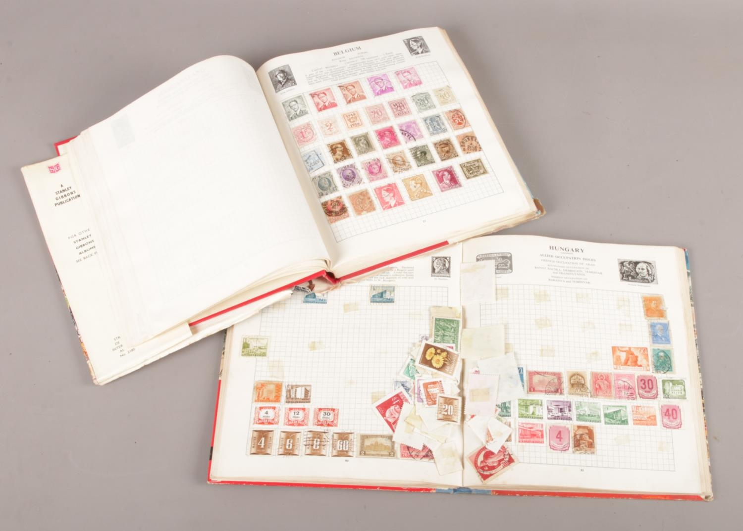 Two Stanley Gibbons stamp albums with contents of world stamps.