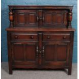 A carved and panelled oak court cupboard. (125cm x 121cm)