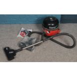 A Numatics International 'Henry' Hoover with accessories.