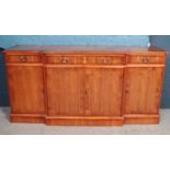 A yewood breakfront sideboard. (90cm x 183cm)