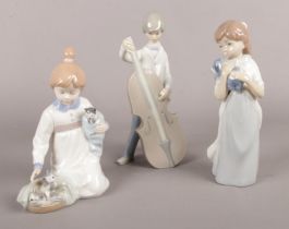 Three Lladro/Nao figurines. girl with kittens, boy with cello etc damage to top of cello on