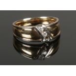 A 9ct gold and diamond ring, set with two 1/16ct stones. Stamped 375. Size X. Total weight: 8.94g