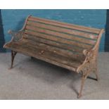 A garden bench with cast iron bench end with floral decoration.