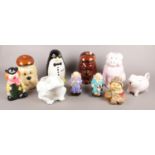 A quantity of novelty ceramic items. Includes biscuit barrels, frog planter and money boxes.