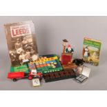 A collection of games and toys. To include Bakelite draughts, miniature metal dominoes and Spear's