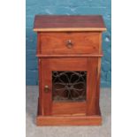 A small hardwood cabinet with iron panelled door. (70cm x 45cm)