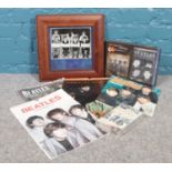 A collection of Beatles memorabilia. Calendars, framed photograph, The Beatles anthology 2 VHS etc