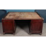 A mahogany partners desk, fitted with eight drawers to one side (one missing) and two cupboards to