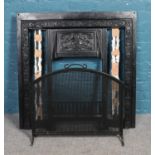 A wrought iron fire surround, together with grate and pierced fire screen. Size of surround: Height: