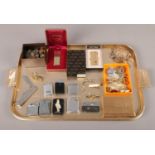 A tray of collectables. To include a boxed Ronson lighter and two other examples, a Mosta 500