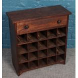 An oak wine rack with single drawer. (66cm x 62cm)