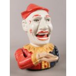 A painted cast iron mechanical money box modelled as a clown. Has lever at the back to lift up the