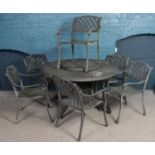 A painted aluminium circular patio table and six matching chairs.