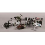 Eight fishing reels. Includes Olympic Atlantis 2400, Ryobi LX02 and LX03.