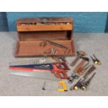 A large wooden carpenters tool box with drawer compartment, along with an assortment of tools. To