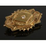 A yellow metal art deco brooch, set with large (¼ct) single diamond. Total weight: 9.45g