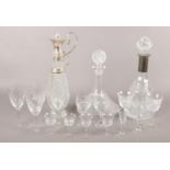 A collection of glassware. Includes white metal mounted claret jug and decanter, drinking glasses