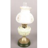 A glass oil lamp with floral decoration.