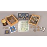 An assortment of coins and notes from UK and World. To include five £1 notes, a boxed set of pre-