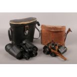 A cased pair of ETABL world war one binoculars along with a pair of Tasco 10x50 Model 312