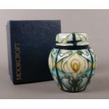 A Moorcroft Cala Lily small ginger jar and cover. 11.5cm height. Marks to base. boxed.