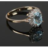 A 9ct Gold, Diamond and blue topaz halo ring. Size: L. Total weight: 1.76g