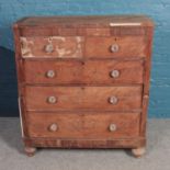 A mahogany chest of two over three drawers with glass handles, raised on turned feet. Height: 121cm,
